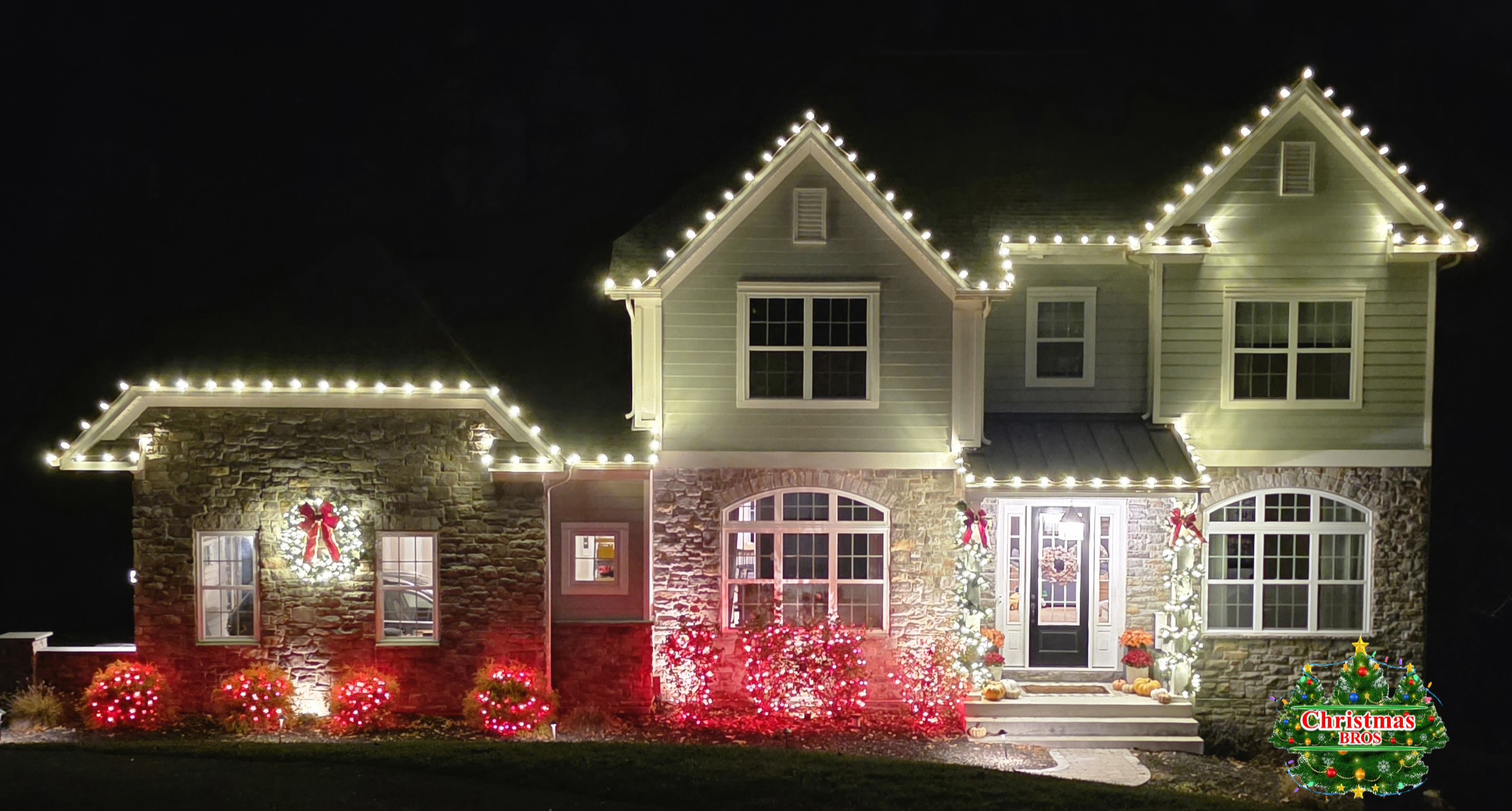 Christmas Bros crew installing warm white roofline lighting on a Delaware home.