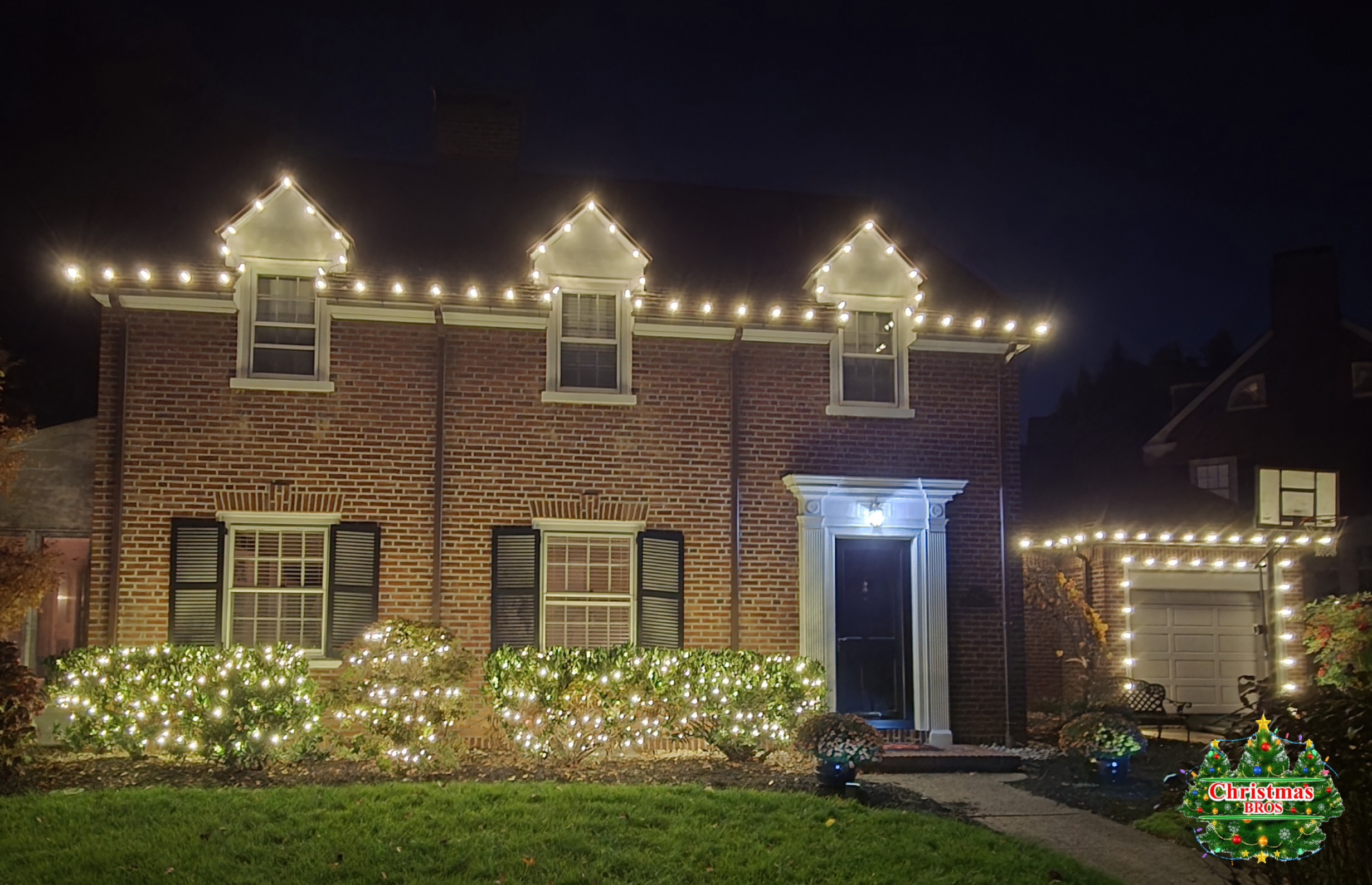 Straight run along the eave, up and over all three dormer peaks, then out across the garage. Simple — and it has to be perfect to look this way.